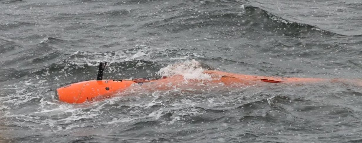 photograph-of-an-orange-long-rov-surfacing-in-choppy-grey-water-l.jpg